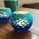 Round glass votive candle holder with fish decorative laser